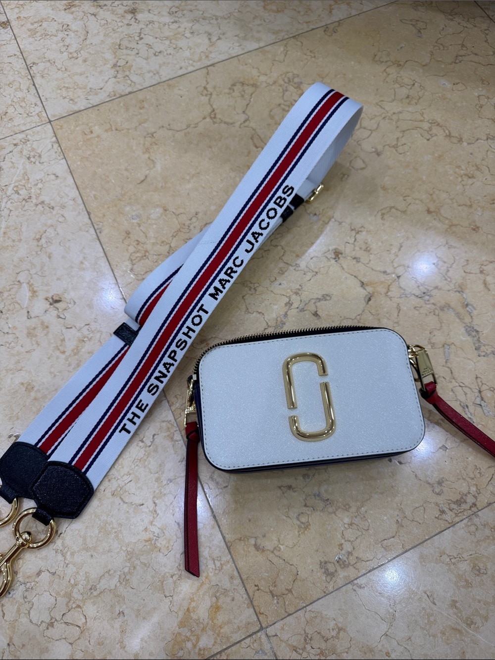 Marc Jacobs white camera crossbody with red-accent strap